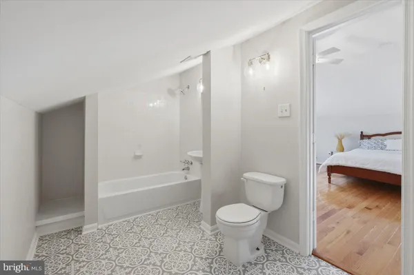 a bathroom with a toilet a sink and bathtub