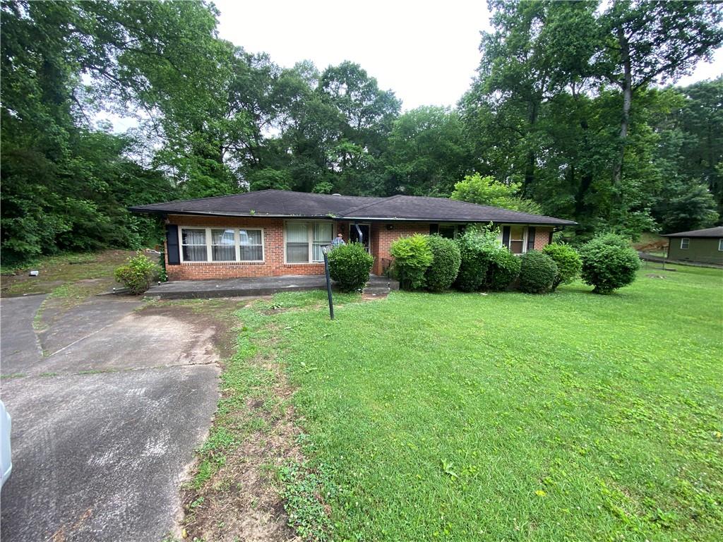 a view of house with yard and green space