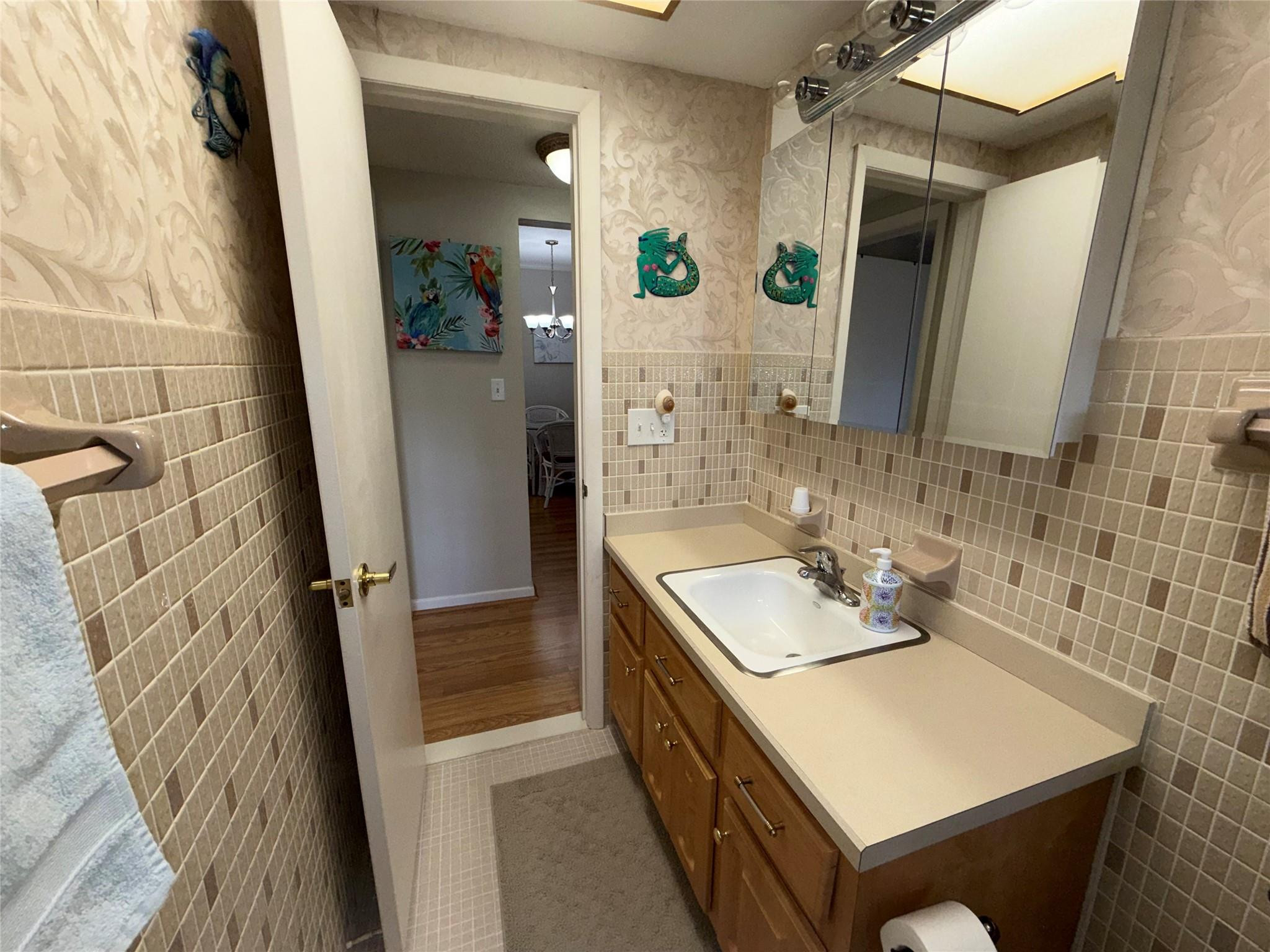 Undisclosed Address Boca Raton, FL 33431 - Photo 14 of 32 a bathroom with a sink a mirror and shower