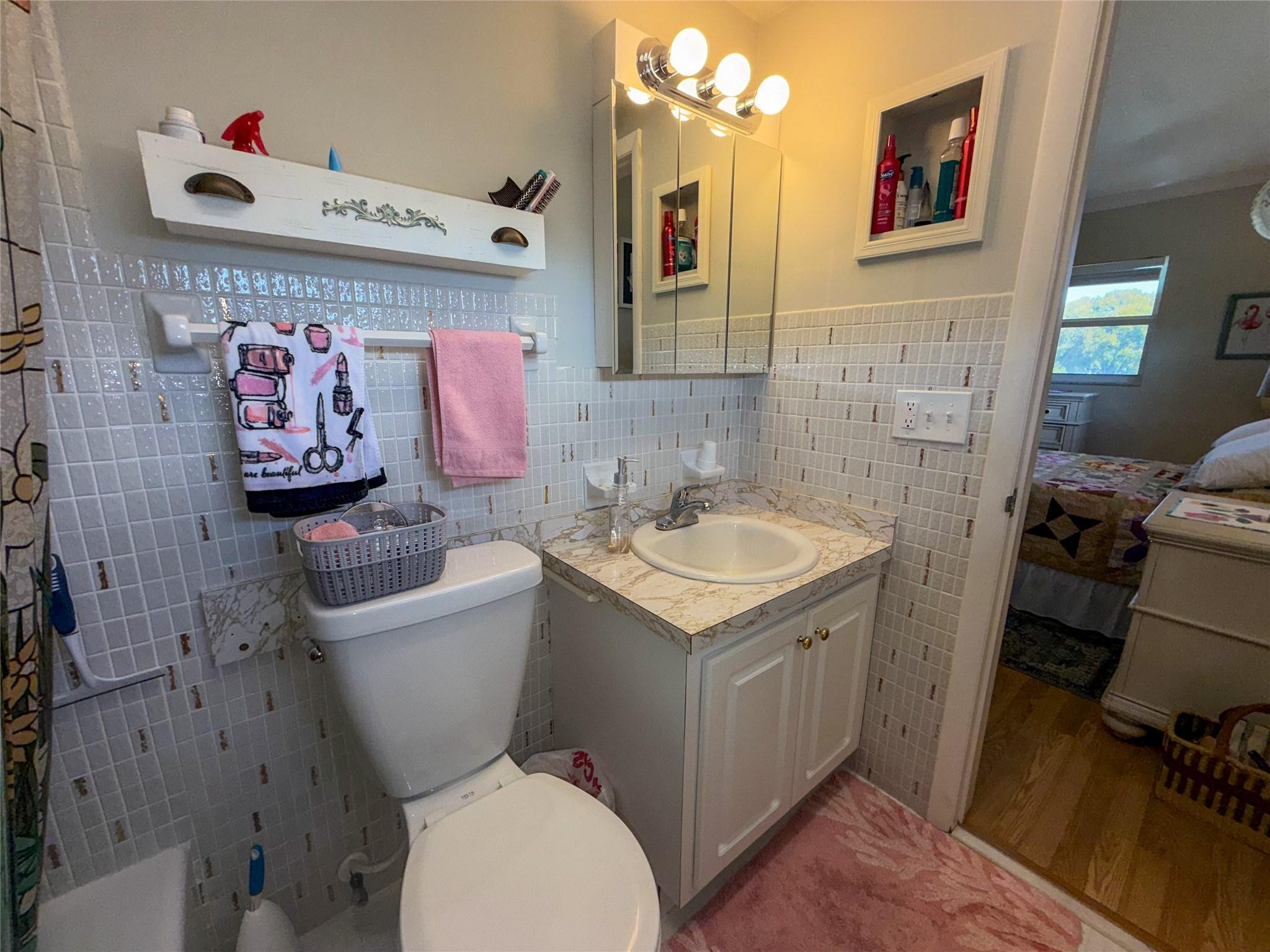 Undisclosed Address Boca Raton, FL 33431 - Photo 27 of 32 a bathroom with a sink mirror vanity and toilet