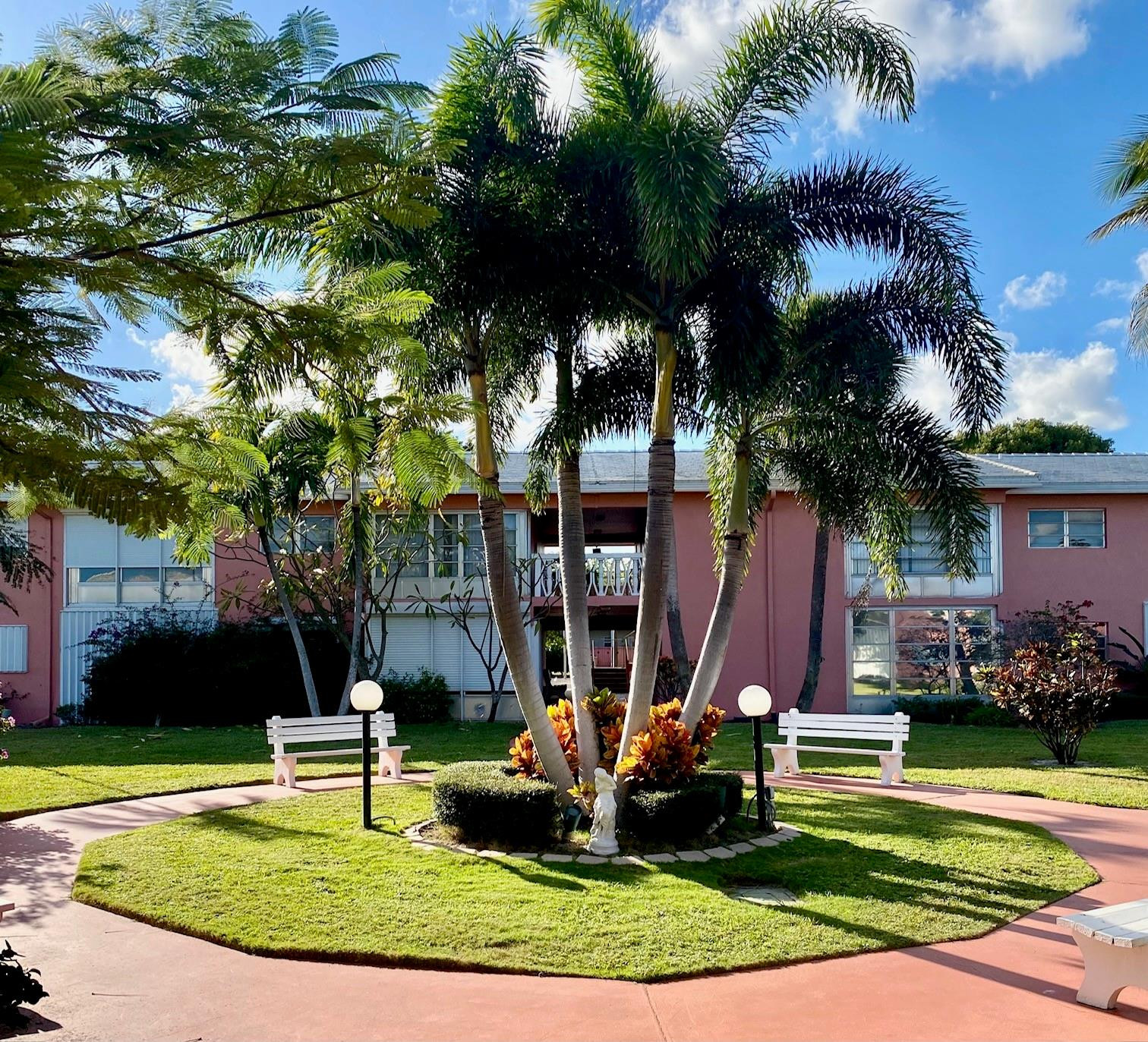 Undisclosed Address Boca Raton, FL 33431 - Photo 32 of 32 a front view of a house with garden and sitting area