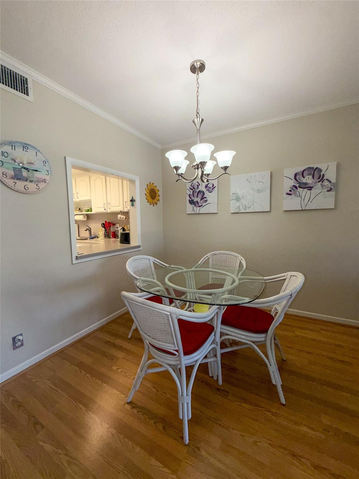 Undisclosed Address Boca Raton, FL 33431 - Photo 7 of 32 a view of a dining room with furniture a chandelier and wooden floor