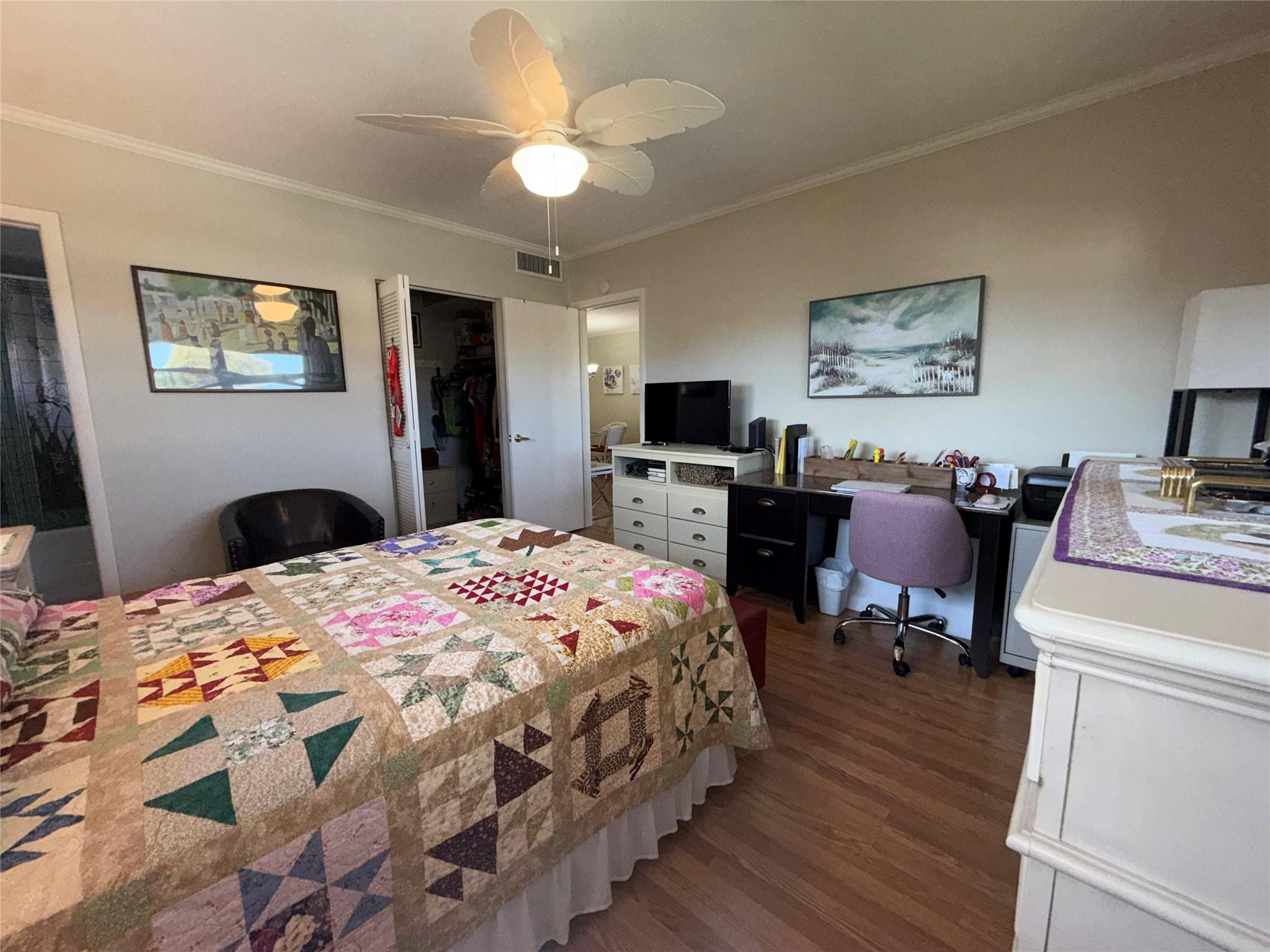 Undisclosed Address Boca Raton, FL 33431 - Photo 8 of 32 a bedroom with wooden floor bed and a chandelier