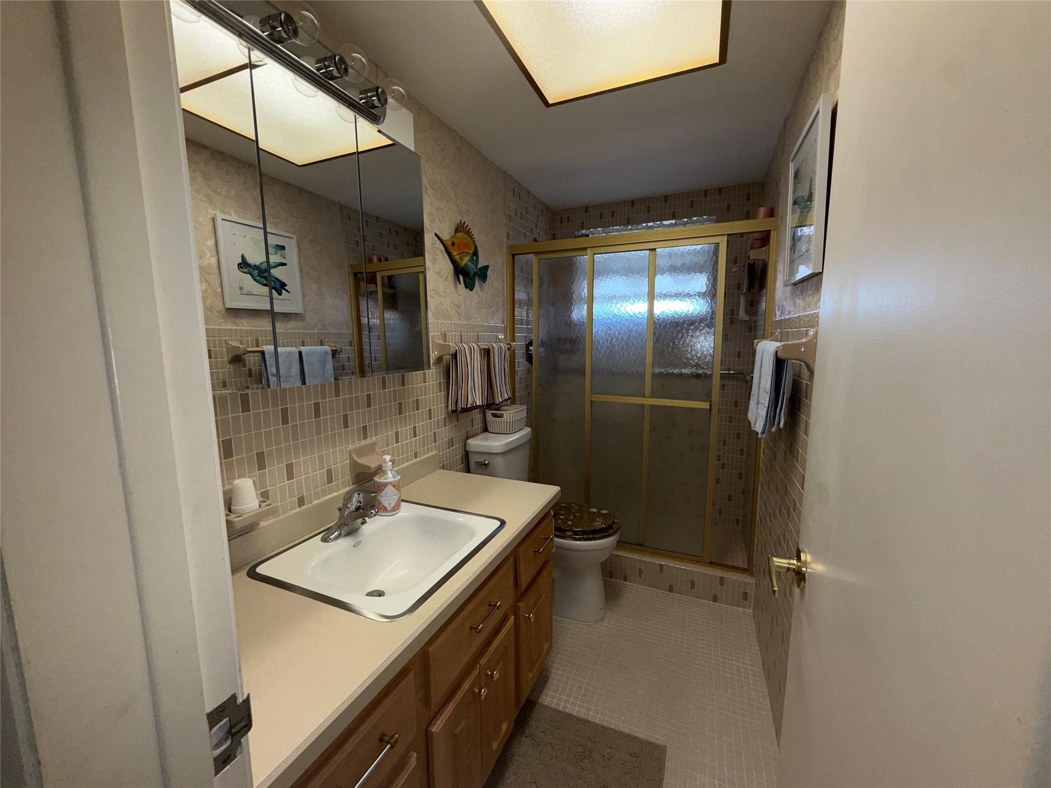 Undisclosed Address Boca Raton, FL 33431 - Photo 10 of 32 a bathroom with a sink toilet and shower