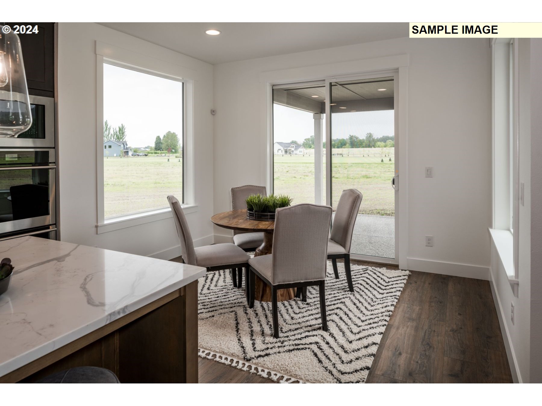 1104 South Mountain Place Ridgefield, WA 98642 - Photo 8 of 8 a dining room with furniture and wooden floor