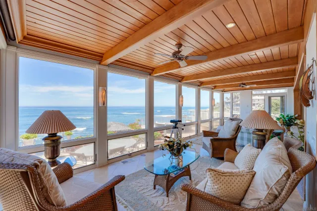 a dining hall with stainless steel appliances granite countertop a stove and a refrigerator