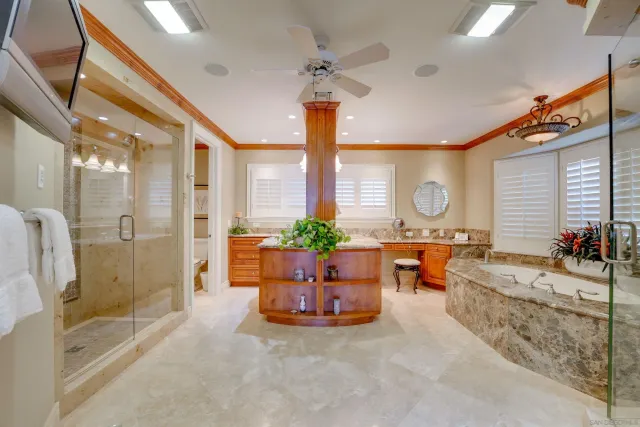 a bedroom with a bed and dresser with wooden floor