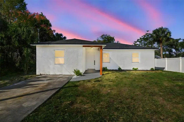 a view of backyard with house and green space