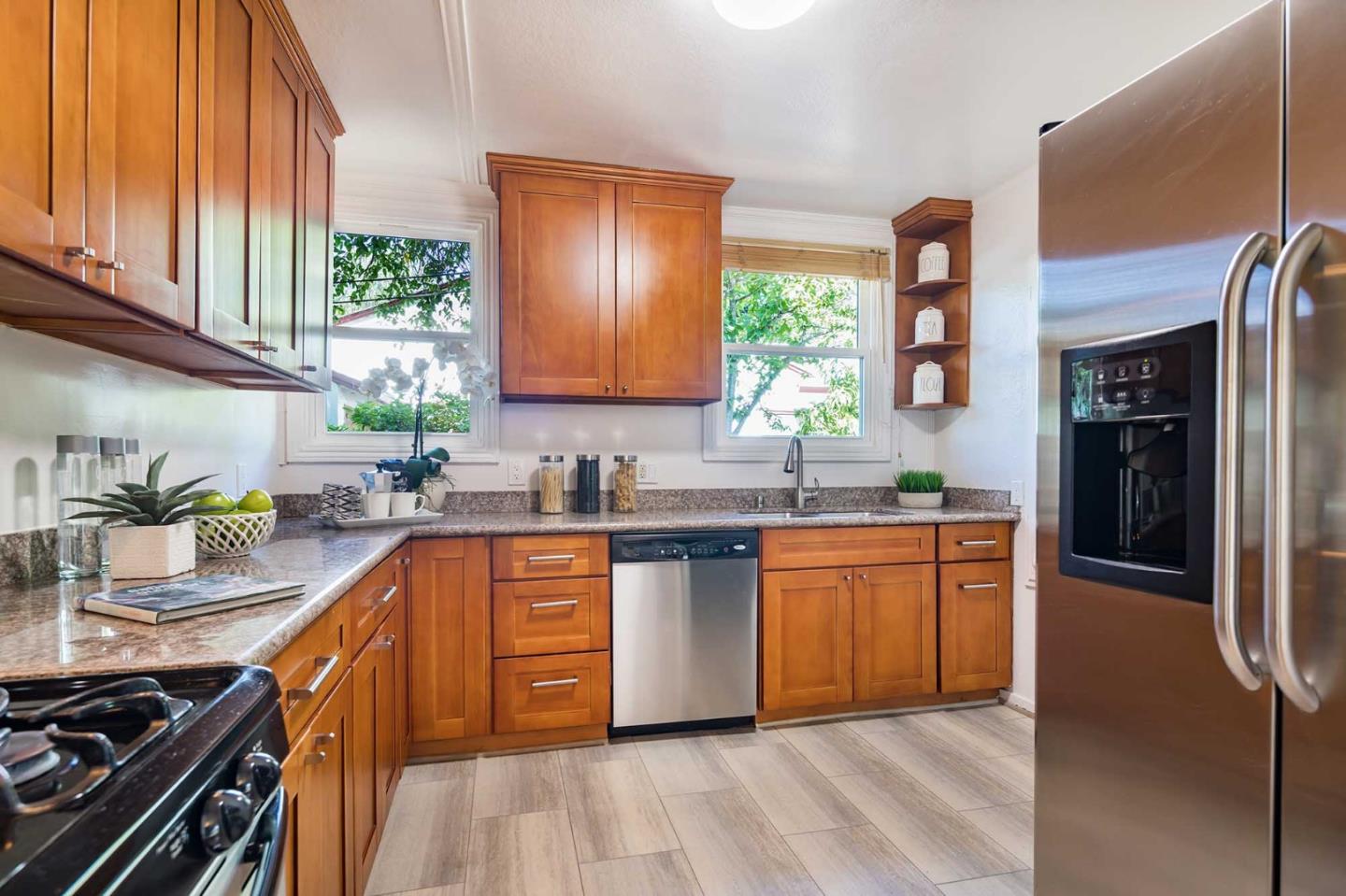 1110 Embarcadero Road Palo Alto, CA 94303 - Photo 12 of 23 a kitchen with stainless steel appliances granite countertop a sink stove and refrigerator