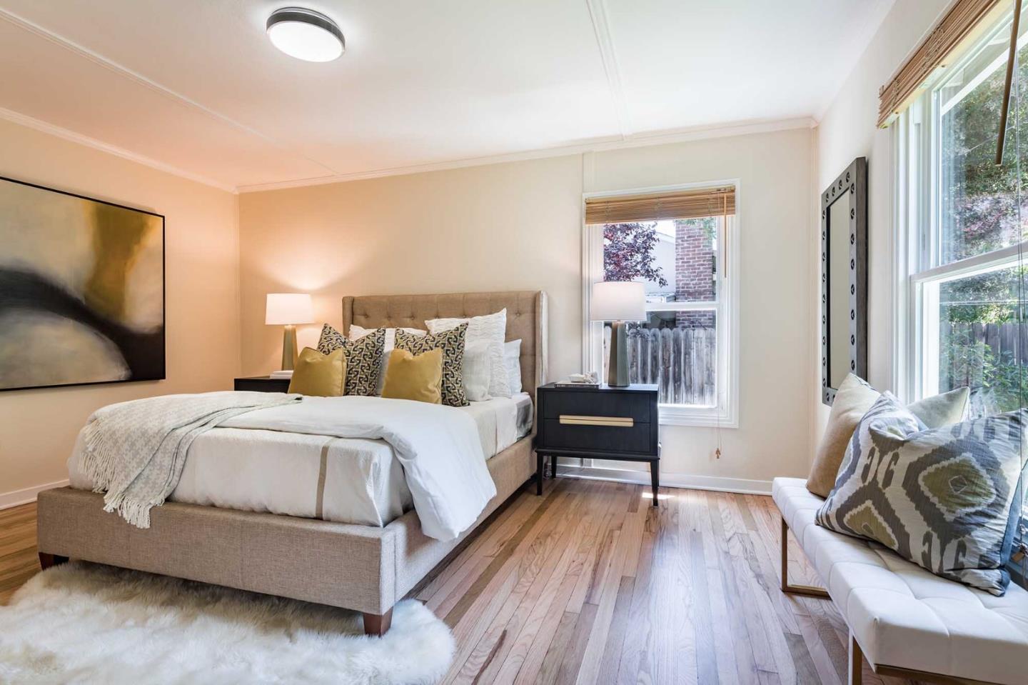 1110 Embarcadero Road Palo Alto, CA 94303 - Photo 15 of 23 a bedroom with a bed and wooden floor