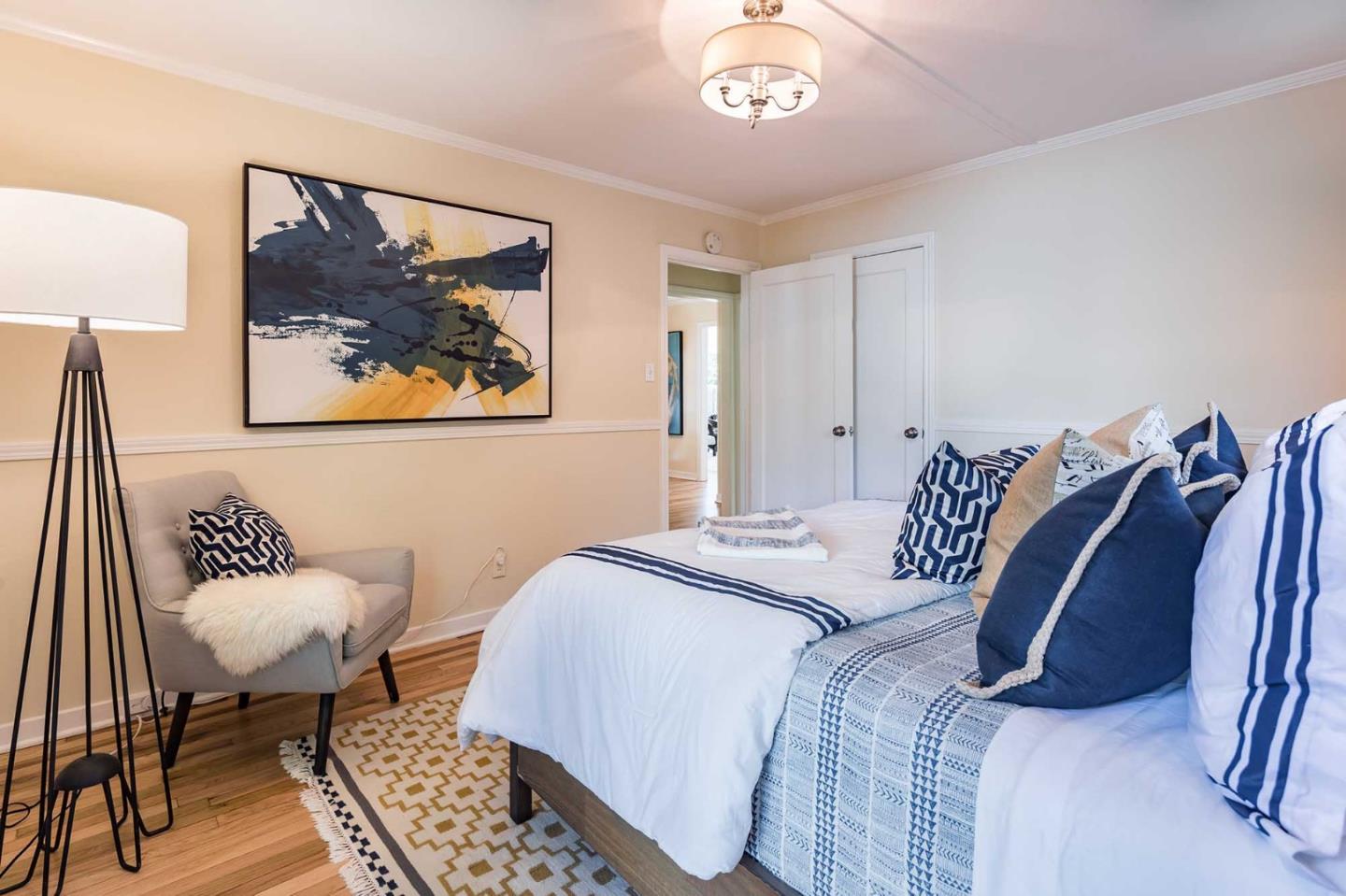 1110 Embarcadero Road Palo Alto, CA 94303 - Photo 17 of 23 a bedroom with a bed and a chair