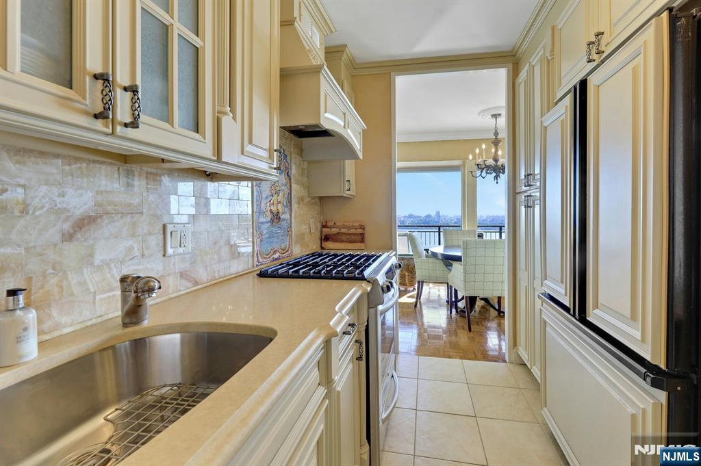 1 Horizon Road, Unit 817 Fort Lee, NJ 07024 - Photo 15 of 44 a kitchen with a sink and a stove top oven