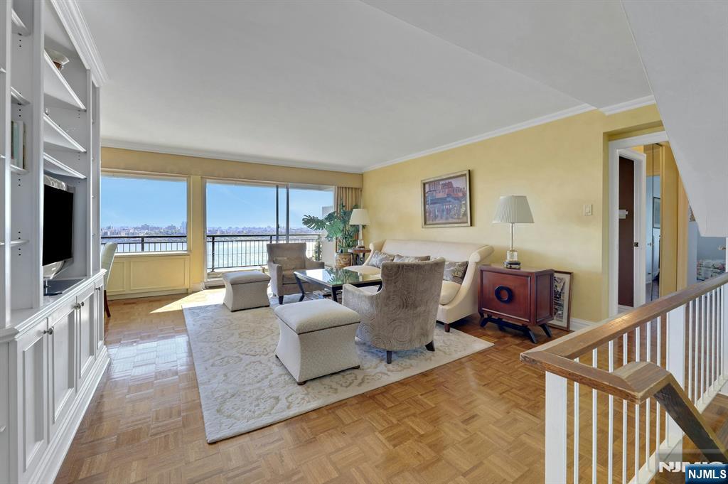1 Horizon Road, Unit 817 Fort Lee, NJ 07024 - Photo 19 of 44 a living room with fireplace furniture and a flat screen tv