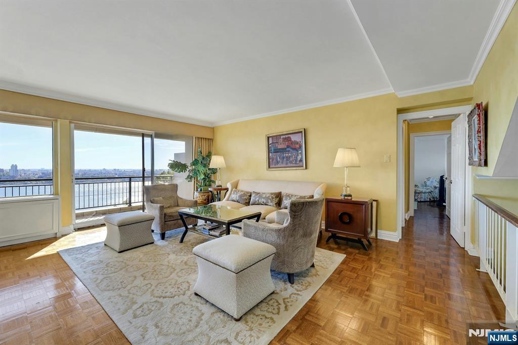 1 Horizon Road, Unit 817 Fort Lee, NJ 07024 - Photo 20 of 44 a living room with furniture and a floor to ceiling window
