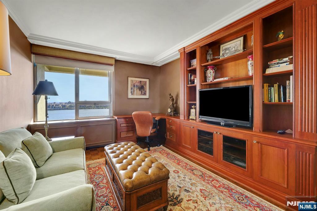 1 Horizon Road, Unit 817 Fort Lee, NJ 07024 - Photo 24 of 44 a living room with furniture a flat screen tv and a flat screen tv
