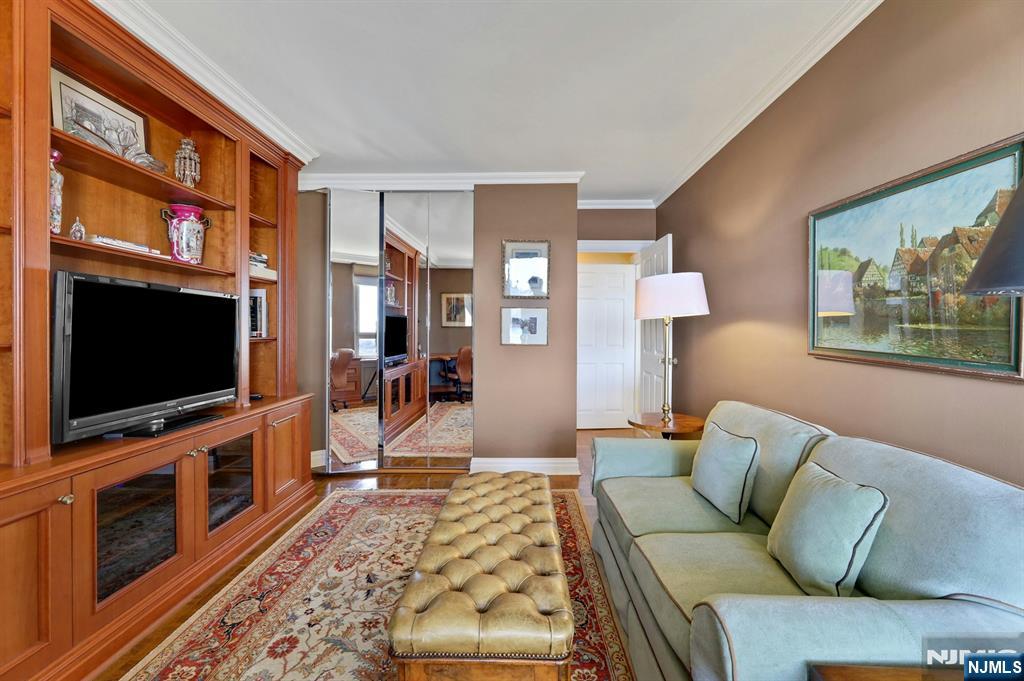 1 Horizon Road, Unit 817 Fort Lee, NJ 07024 - Photo 27 of 44 a living room with furniture and a flat screen tv