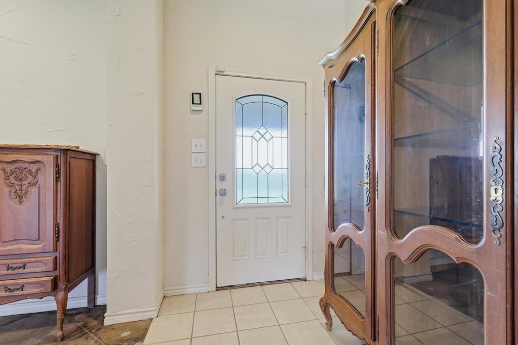 12190 Bell Road Pilot Point, TX 76258 - Photo 5 of 39 Entryway featuring a white door with decorative glass inserts and light-toned square tile flooring