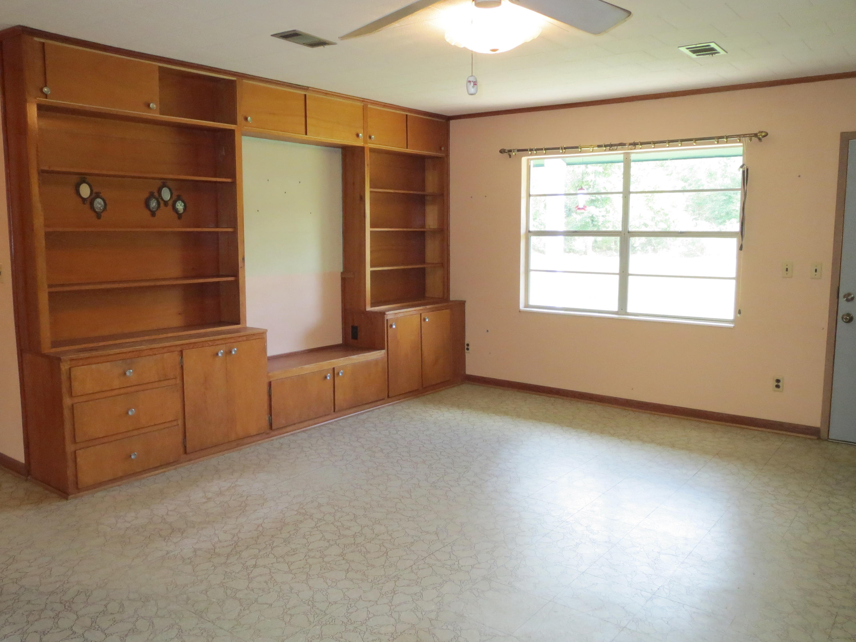 586 Mossy Bend Road Ponce de Leon, FL 32455 - Photo 4 of 17 an empty room with windows and cabinet