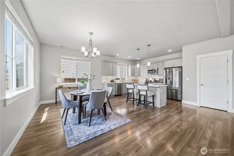 a view of a dining room with furniture and wooden floor