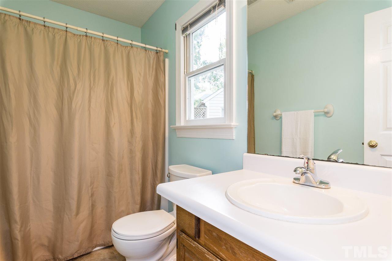2228 Bufflehead Road Raleigh, NC 27616 - Photo 16 of 20 a bathroom with a sink a toilet and tub