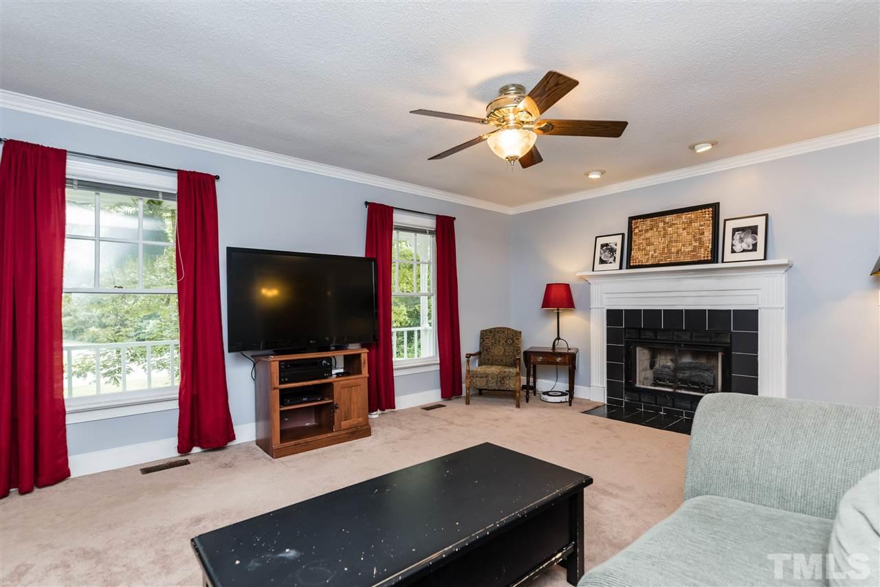 2228 Bufflehead Road Raleigh, NC 27616 - Photo 3 of 20 a living room with furniture flat screen tv and a fireplace