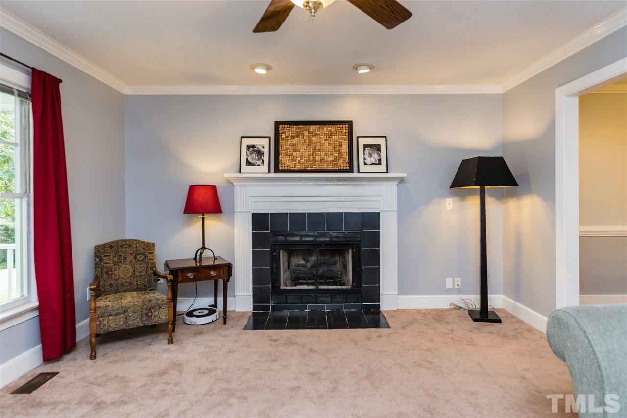 2228 Bufflehead Road Raleigh, NC 27616 - Photo 4 of 20 a living room with furniture and a fireplace