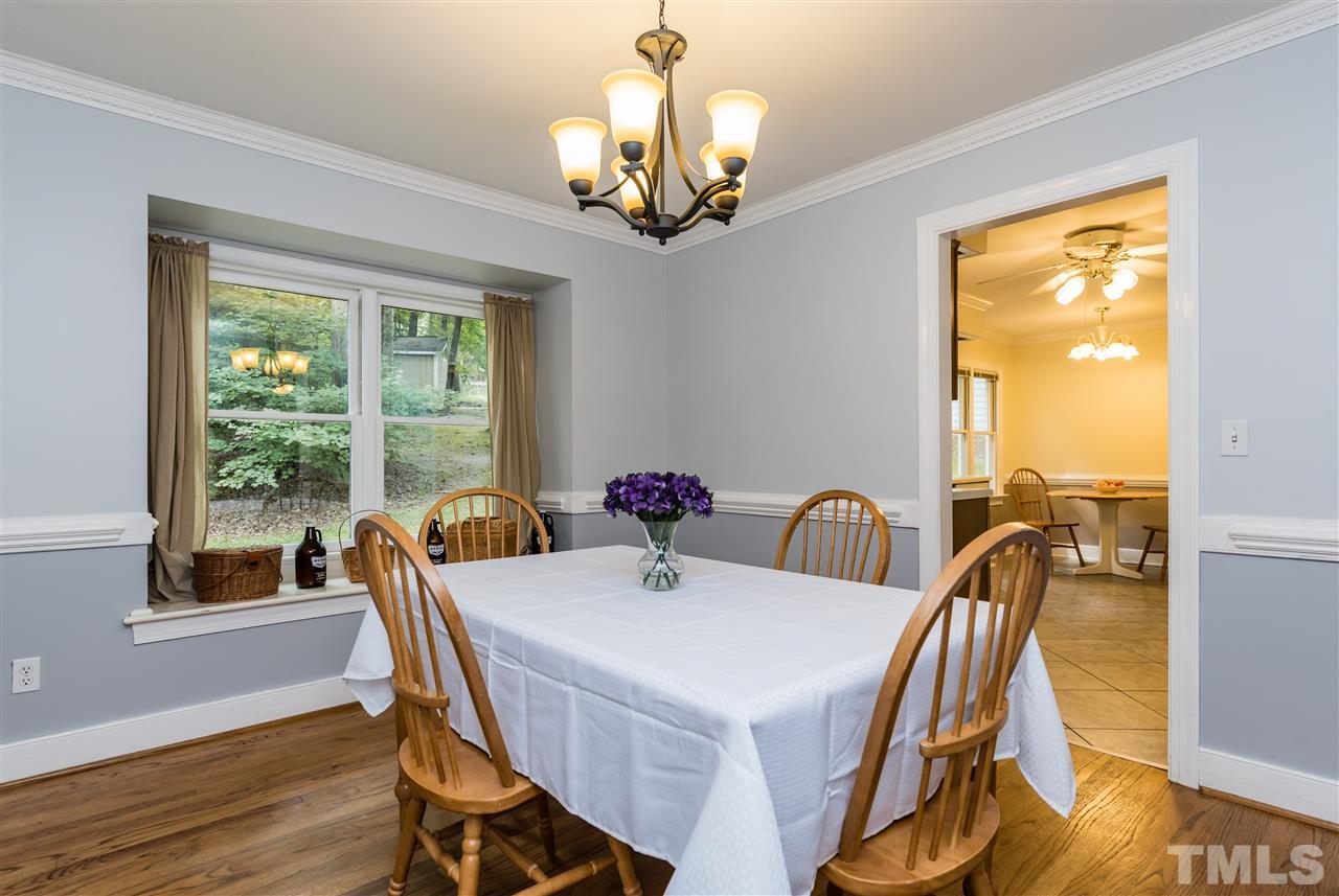 2228 Bufflehead Road Raleigh, NC 27616 - Photo 5 of 20 a view of a dining room with furniture a chandelier and wooden floor