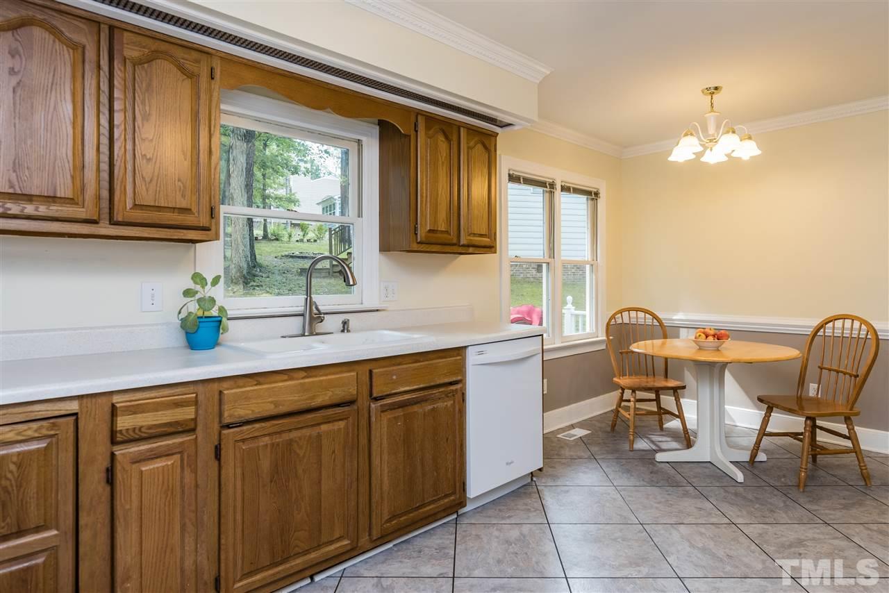 2228 Bufflehead Road Raleigh, NC 27616 - Photo 7 of 20 a kitchen with a sink dining table and chairs