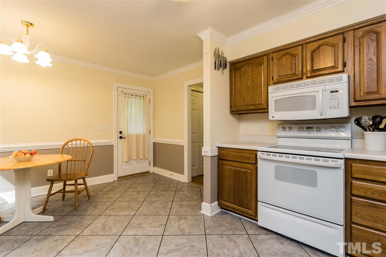 2228 Bufflehead Road Raleigh, NC 27616 - Photo 10 of 20 a kitchen with stainless steel appliances a stove a sink and a microwave