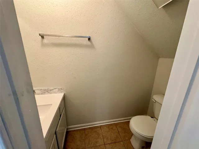 a white toilet sitting next to a shower