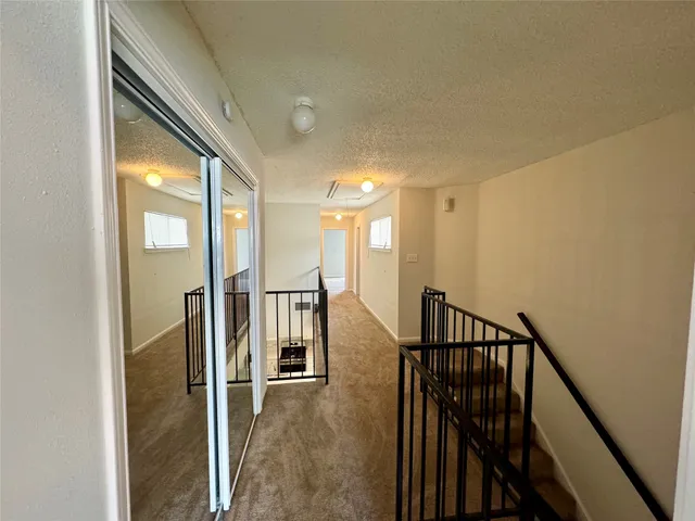 a view of entryway with wooden floor and livingroom view