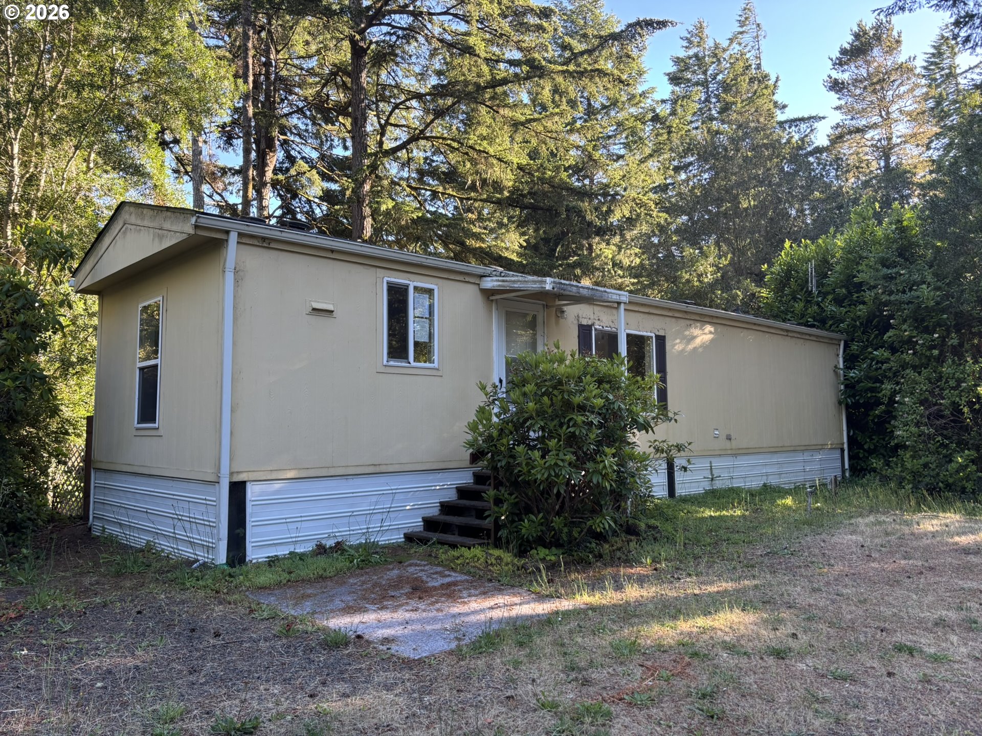64 Outer Drive Florence, OR 97439 - Photo 2 of 8 a house that has a tree in front of the house