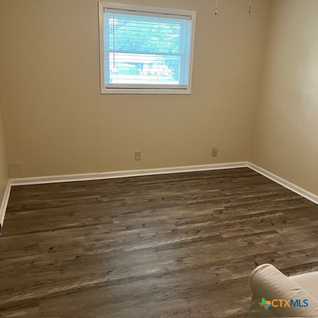 3905 Mariam Road Temple, TX 76502 - Photo 14 of 17 a view of an empty room with wooden floor and a window