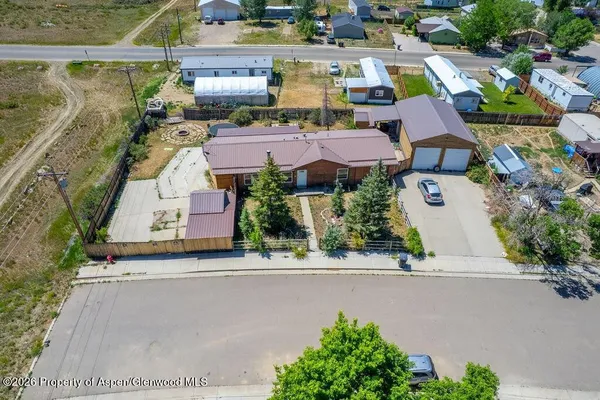 an aerial view of a house with yard
