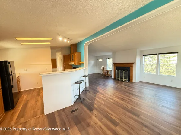 a view of living room with furniture and fireplace