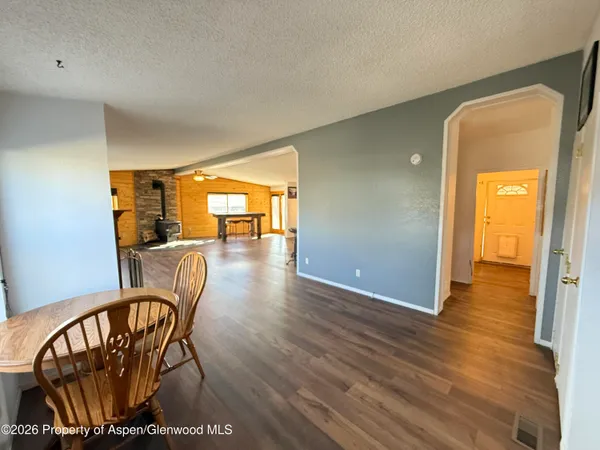 a view of a livingroom with furniture wooden floor and windows