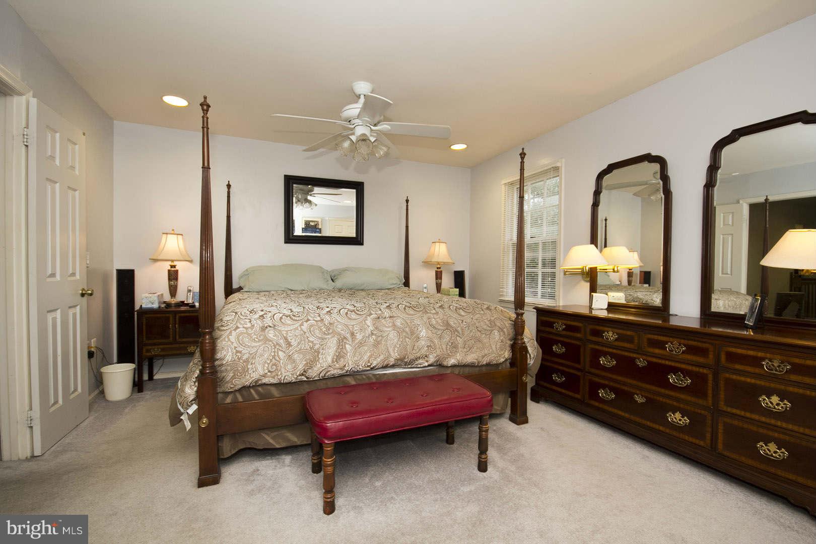 13608 Turnmore Road Silver Spring, MD 20906 - Photo 14 of 30 a bedroom with a bed and a dresser with mirror