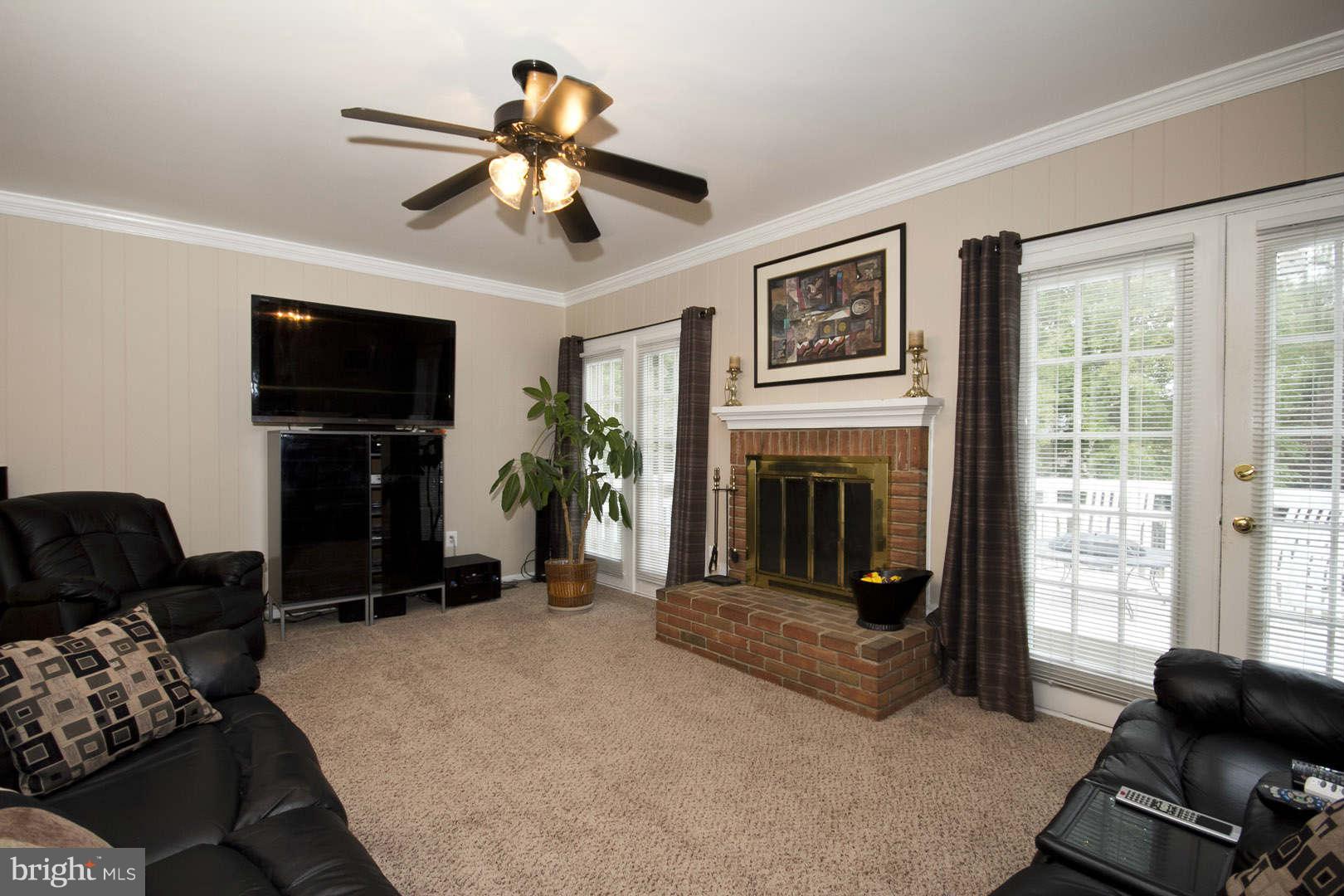 13608 Turnmore Road Silver Spring, MD 20906 - Photo 10 of 30 a living room with furniture and a fireplace