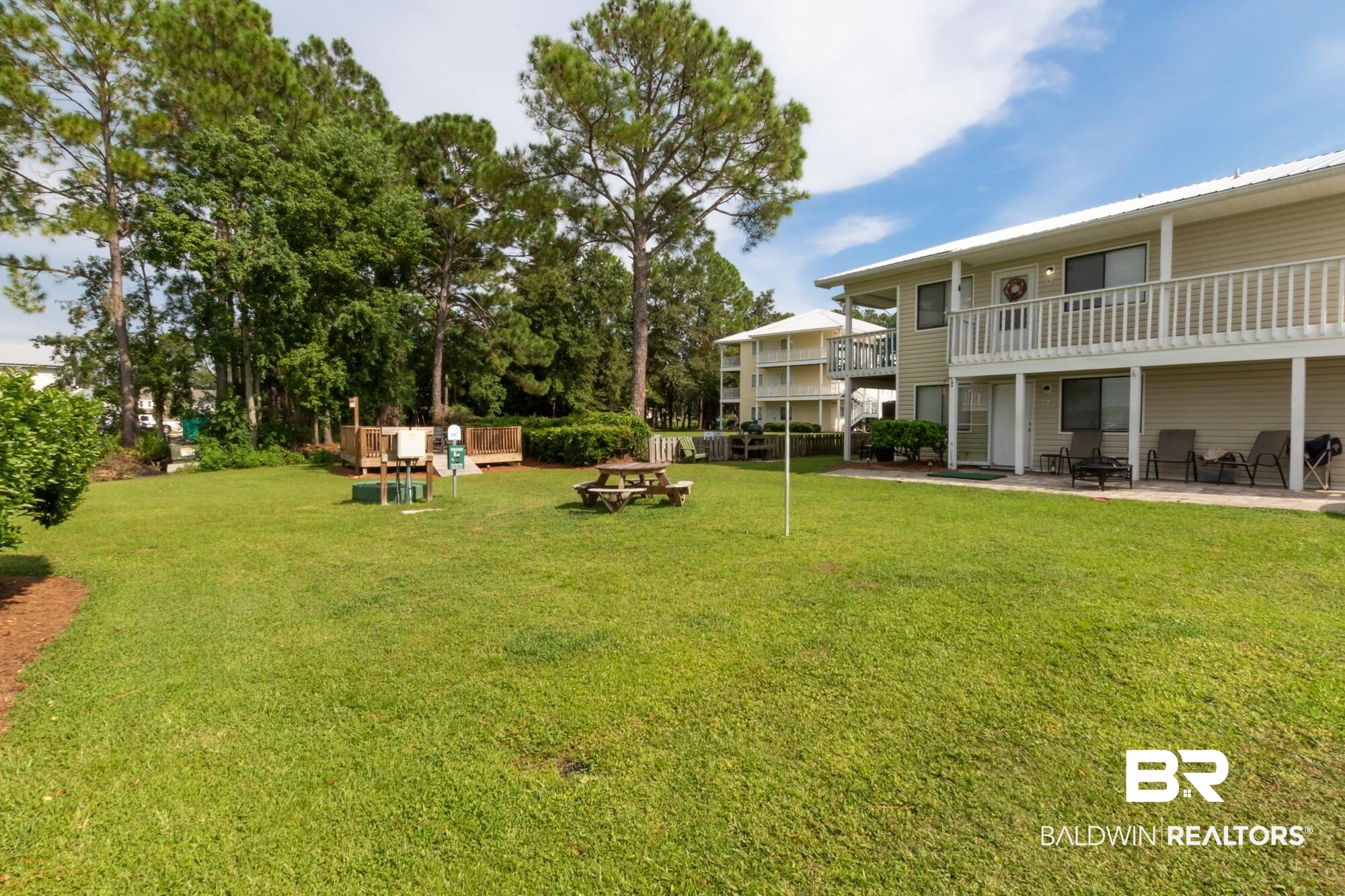 25925 -C Canal Road, Unit 203 Orange Beach, AL 36561 - Photo 37 of 57 View of yard featuring an outdoor fire pit and a patio