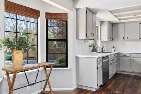 a kitchen with a table chairs sink and cabinets