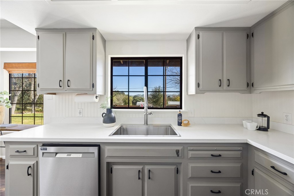 6030 Portola Road Atascadero, CA 93422 - Photo 13 of 44 a kitchen with stainless steel appliances white cabinets and a window