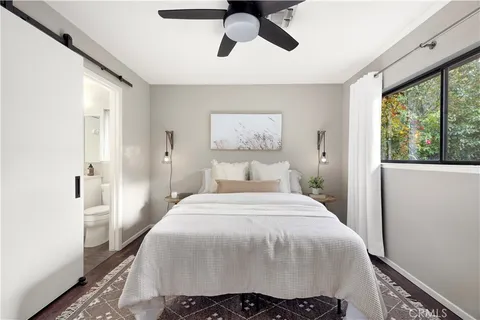 a bedroom with a bed and glass window