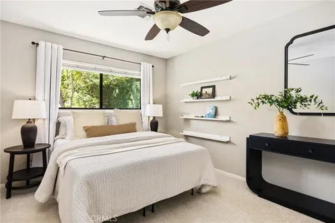 a bedroom with a bed and a potted plant