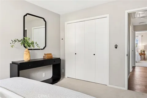 a bedroom with a bed and a potted plant