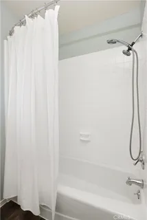 a bathroom with a shower and a bath tub