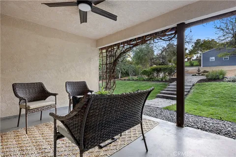 a view of a chairs in backyard of the house