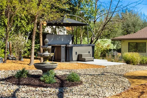 a view of a house with backyard and sitting area