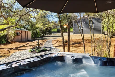 a view of backyard with swimming pool and outdoor seating