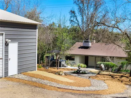 a view of a house with backyard and sitting area