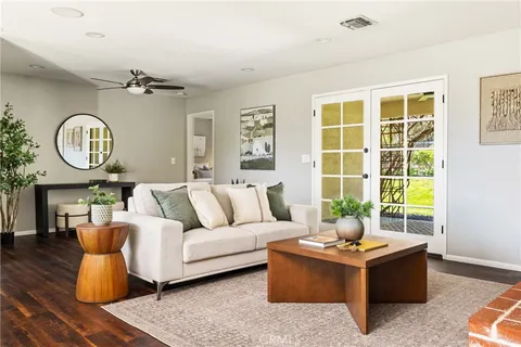 a living room with furniture a window and a clock
